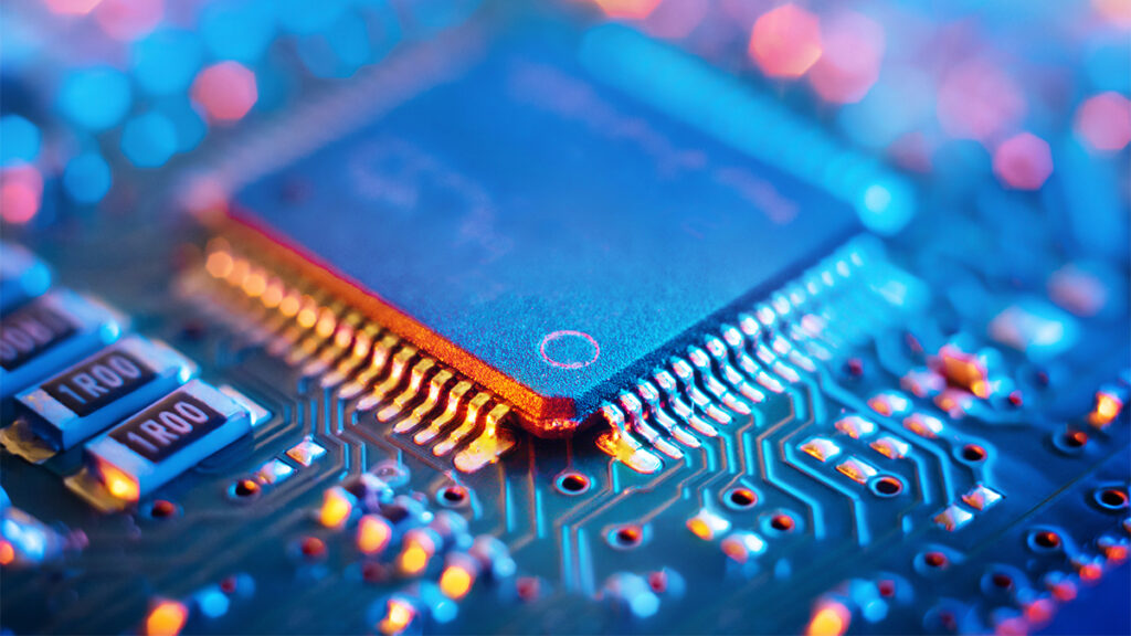 Computer Microchips and Processors on Electronic circuit board. Abstract technology microelectronics concept background. Macro shot, shallow focus.